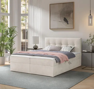 A bedroom scene featuring a boxspring bed.