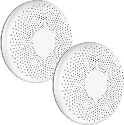 Two white circular smoke and carbon monoxide detectors are shown against a white background.