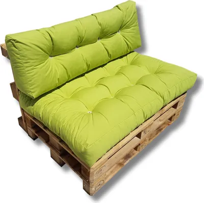 A green cushion set on a wooden pallet.