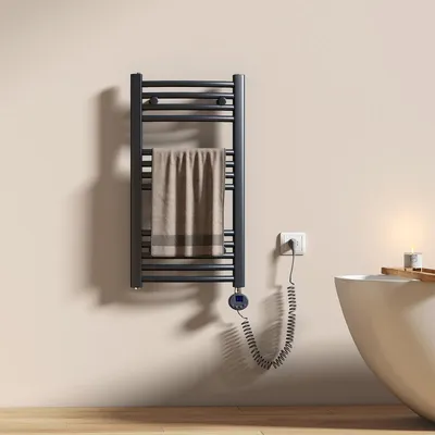 A bathroom setting with a towel warmer, bathtub, and candle.