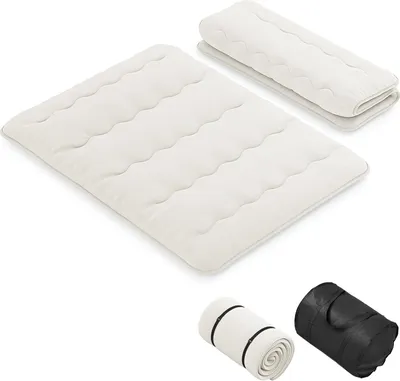 A folded and unfolded mattress, along with two rolled-up mattresses in carrying bags.