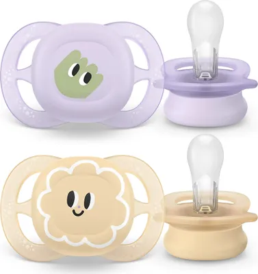 Two Philips Avent pacifiers, one purple with a green frog design and one yellow with a lion design, are shown against a white background.