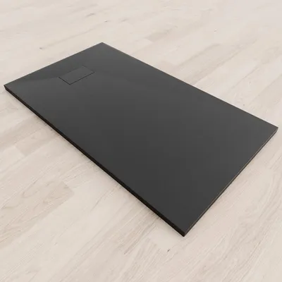 A black shower tray on a light wood-effect floor.