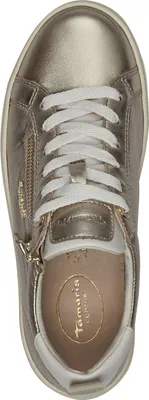 A top-down view of a gold sneaker with white laces.