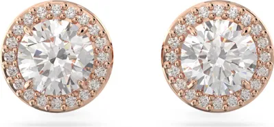 A pair of rose gold stud earrings with a central clear stone surrounded by smaller clear stones.