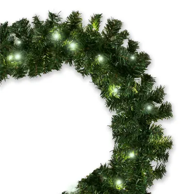 A close-up view of a green artificial Christmas garland with small white lights.