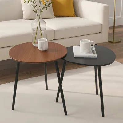 A pair of nesting coffee tables with wooden and black tops.
