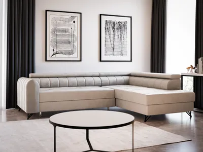 A modern living room with a beige sectional sofa, coffee table, and artwork on the wall.