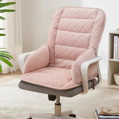 A pink cushioned seat and backrest cover for an office chair, placed on the chair itself in a home or office setting.