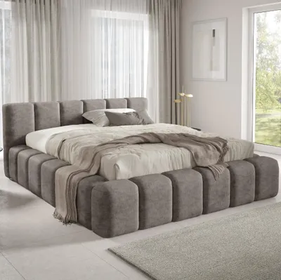 A modern bedroom with a large upholstered bed.