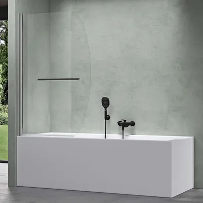 A modern bathroom with a white bathtub and a clear glass shower screen.