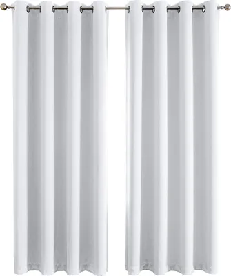 Two white curtains hanging on a curtain rod against a white background.