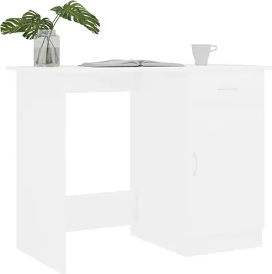 A white desk with a plant and a book on top.