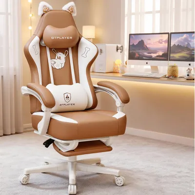 A gaming chair is shown in a room with a desk and computers in the background.