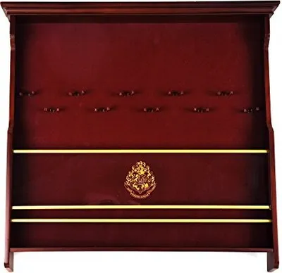 A wooden display shelf for wands, featuring the Hogwarts crest.