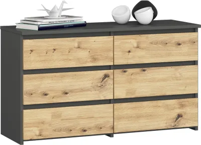 A dresser with six drawers, featuring a dark gray frame and light wood-effect drawer fronts, displayed against a light gray background. Decorative items, including books and two spherical objects, are placed on top.