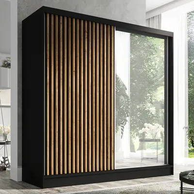 A modern wardrobe with a slatted wood front and a mirrored door.