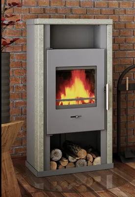 A modern fireplace with a fire burning inside, set against a brick wall and wooden floor.
