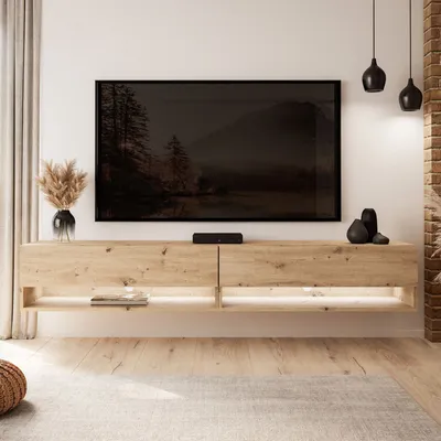 A modern living room with a wall-mounted TV cabinet and a large television.
