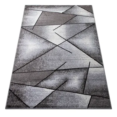 A rectangular rug with a geometric pattern is shown from a slightly elevated angle.