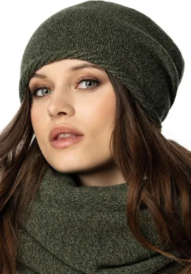 Close-up portrait of a woman wearing a green beanie and scarf.