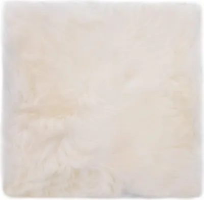 A close-up view of a white sheepskin cushion.