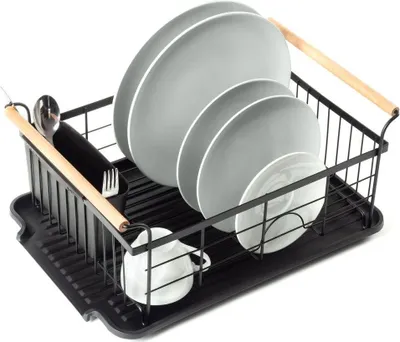 A black dish drying rack filled with plates, a cup, and cutlery.