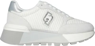 A white sneaker with grey suede details and a silver logo.
