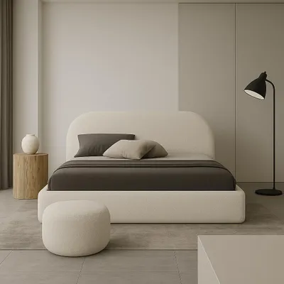 A minimalist bedroom with a large upholstered bed, a side table with a vase, and a floor lamp.