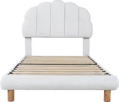 A white bed frame with a slatted base and a padded, scalloped headboard, shown against a white background.