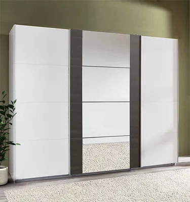 A large white wardrobe with mirrored doors and dark gray accents, set against a muted green wall and a light-colored rug.