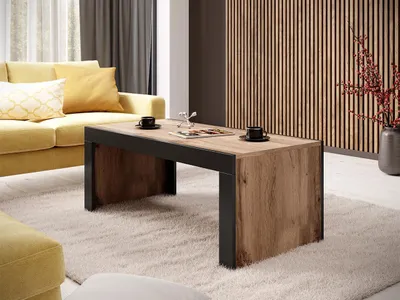 A living room scene with a couch, coffee table, and decorative wall.