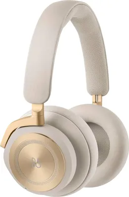 A pair of cream and gold over-ear headphones.