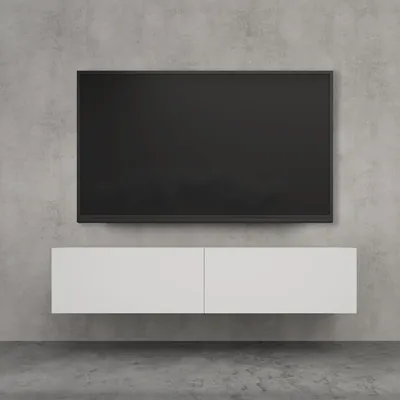 A modern TV mounted on a concrete wall above a floating white cabinet.