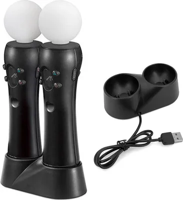 A black charging dock with two black controllers, each topped with a white sphere, and a black USB cable.