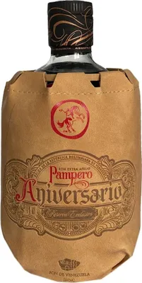 A bottle of Ron Pampero Aniversario Reserva Exclusiva rum, partially wrapped in brown paper packaging.