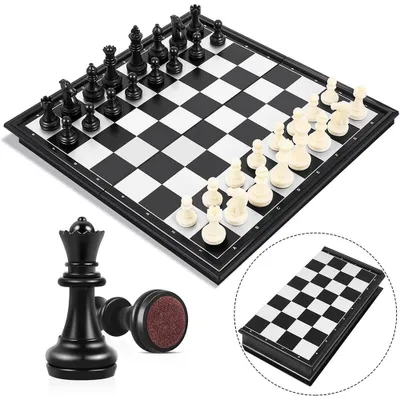 A chess set with black and white pieces on a chessboard, with a close-up of a black queen and a folded chess board.