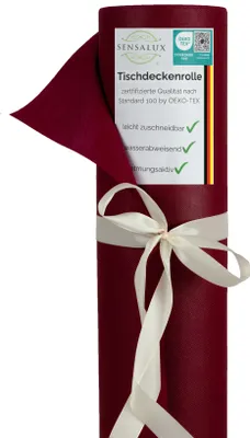 A roll of burgundy tablecloth material tied with a cream ribbon, with a label attached.
