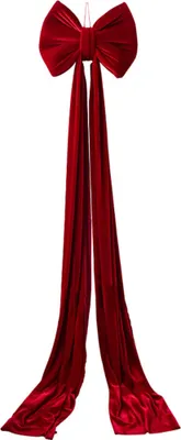 A large red velvet bow with two long streamers, hanging against a white background.