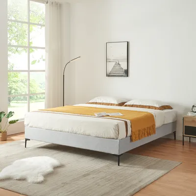 A bedroom scene with a bed, window, and lamp.