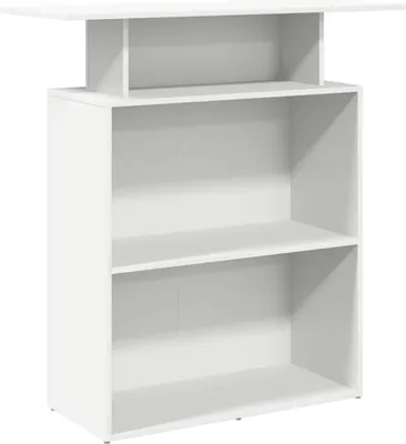 A white reception desk with shelves.