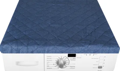 A blue quilted cover is placed on top of a white washing machine.