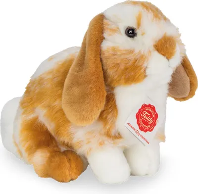 A plush toy rabbit sitting on a white background.
