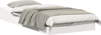 A white bed frame with white and gray bedding.