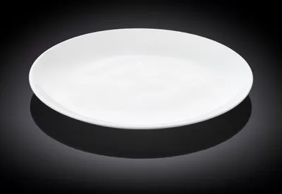 A white plate on a black reflective surface.