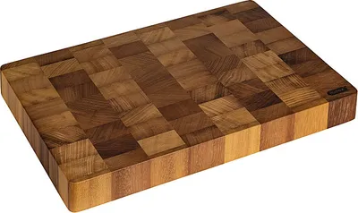 A wooden cutting board made of many small wooden blocks arranged in a pattern.