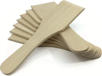 A stack of wooden spatulas on a white background.