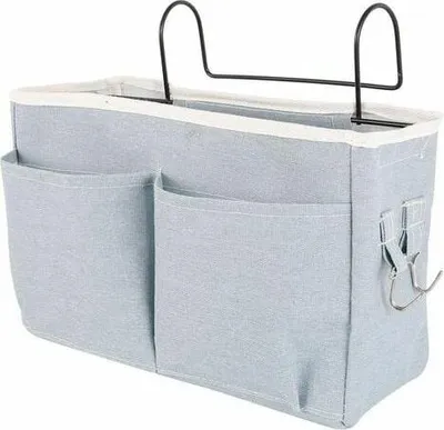 A light blue fabric hanging organizer with multiple pockets and metal hooks.