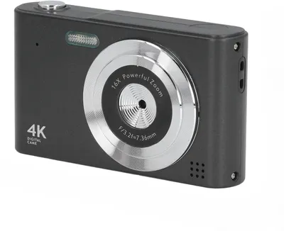 A close-up, angled view of a black digital camera against a white background.