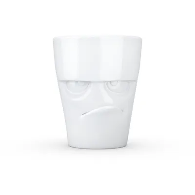 A white ceramic mug with a grumpy face design.